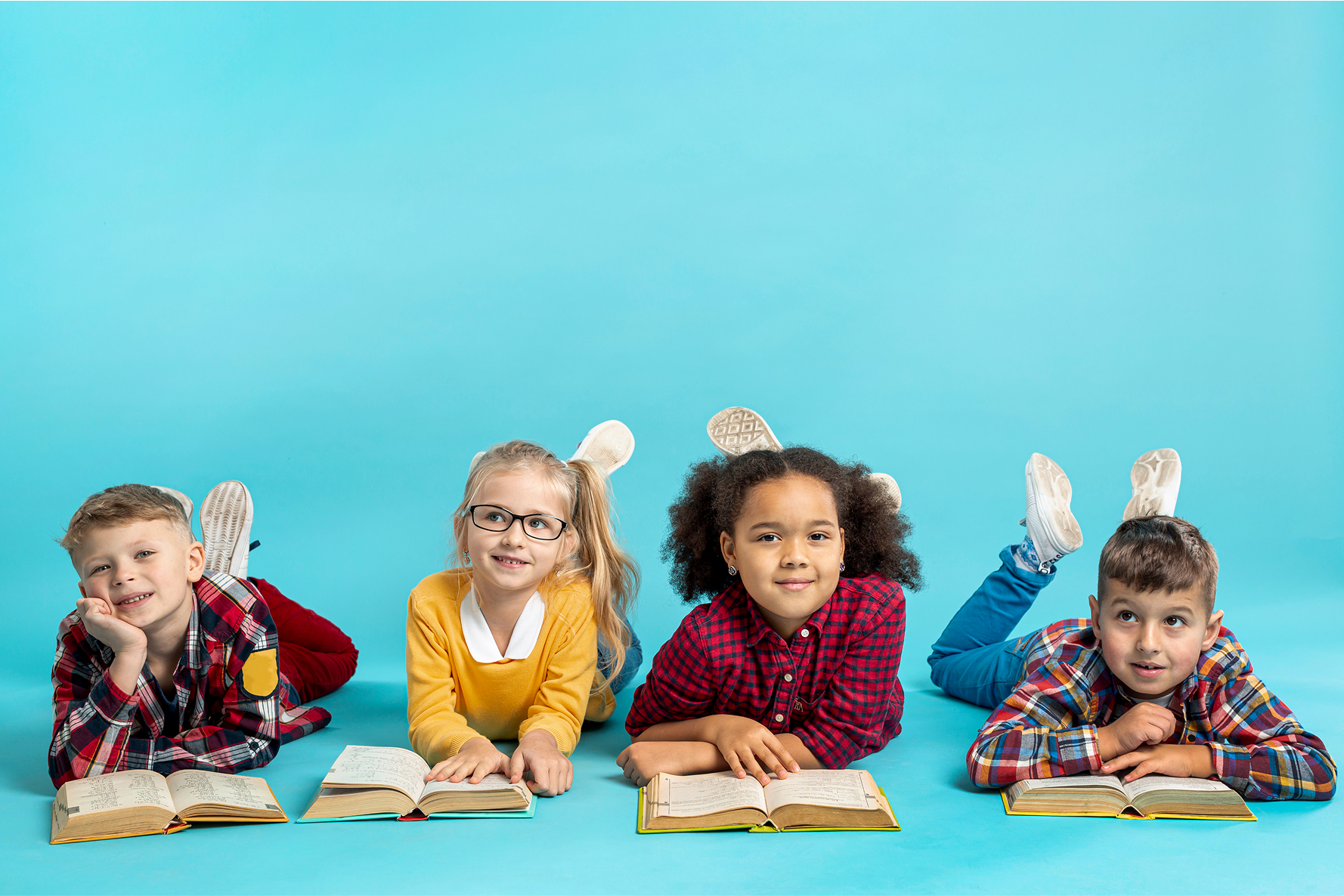 Four children reading books